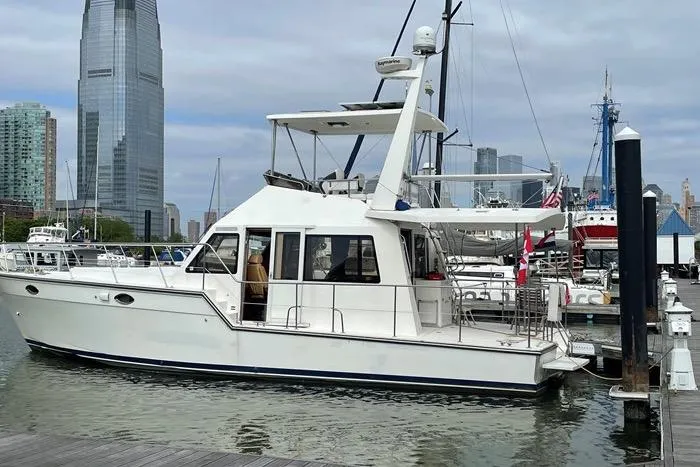  Yacht Photos Pics 2007 Island Pilot 395 yacht docked in urban marina with city skyline.