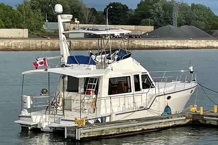  Yacht Photos Pics 2007 Island Pilot 395 yacht docked at a marina with a Canadian flag.