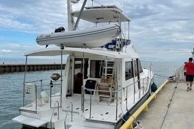  Yacht Photos Pics 2007 Island Pilot 395 yacht docked at a marina with a dinghy on top.
