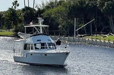  Yacht Photos Pics 2007 Island Pilot 395 cruising on a scenic waterway with lush greenery.