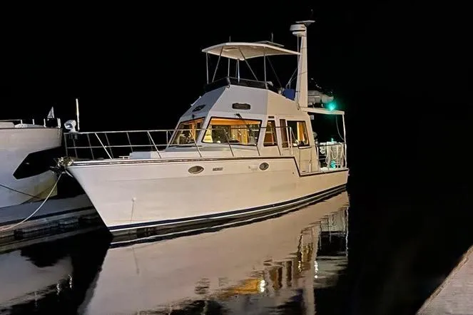  Yacht Photos Pics 2007 Island Pilot 395 yacht docked at night, reflecting on calm water.