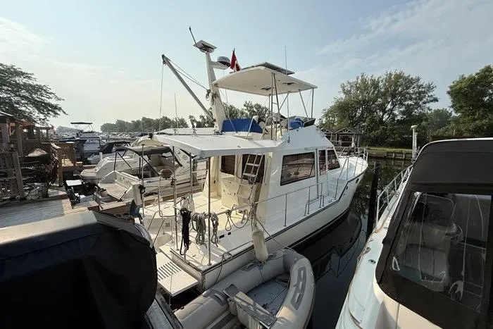  Yacht Photos Pics 2007 Island Pilot 395 yacht docked at marina, surrounded by other boats.