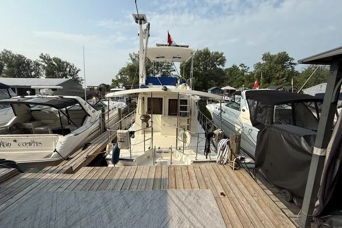  Yacht Photos Pics 2007 Island Pilot 395 docked at marina, surrounded by other boats.