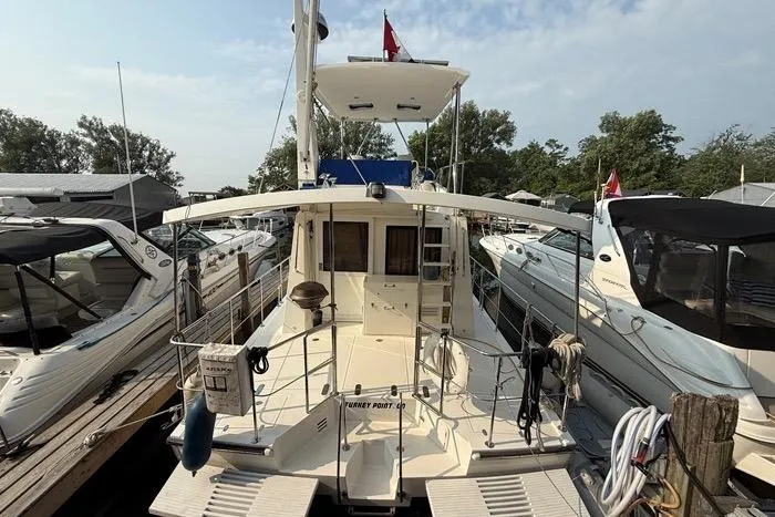  Yacht Photos Pics 2007 Island Pilot 395 yacht docked at marina, surrounded by other boats.