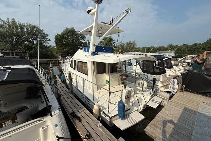  Yacht Photos Pics 2007 Island Pilot 395 yacht docked at marina, surrounded by other boats.
