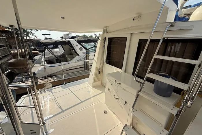  Yacht Photos Pics 2007 Island Pilot 395 yacht deck with railing, ladder, and storage compartments.