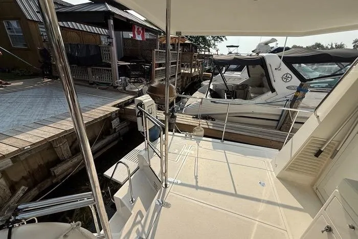  Yacht Photos Pics 2007 Island Pilot 395 docked at marina, featuring spacious deck and nearby boats.