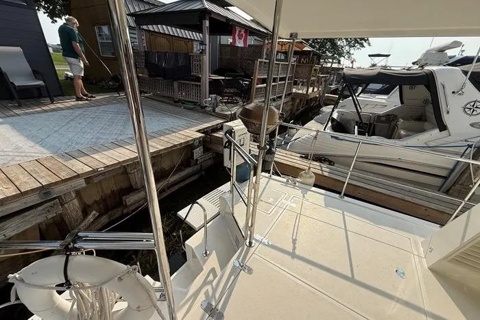  Yacht Photos Pics 2007 Island Pilot 395 docked near wooden pier with Canadian flag.
