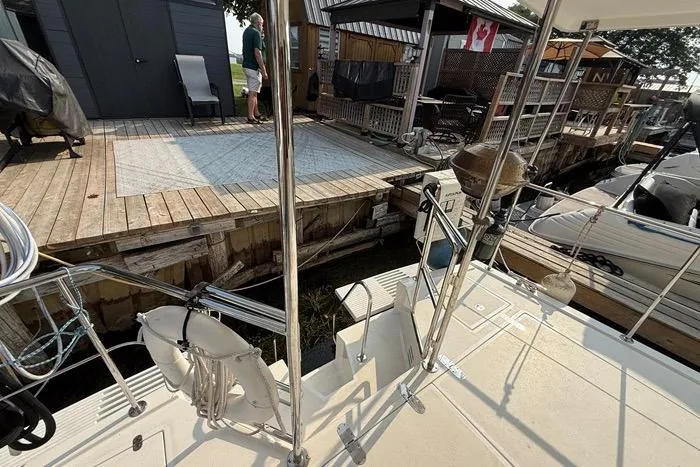  Yacht Photos Pics 2007 Island Pilot 395 docked near wooden deck with Canadian flag.