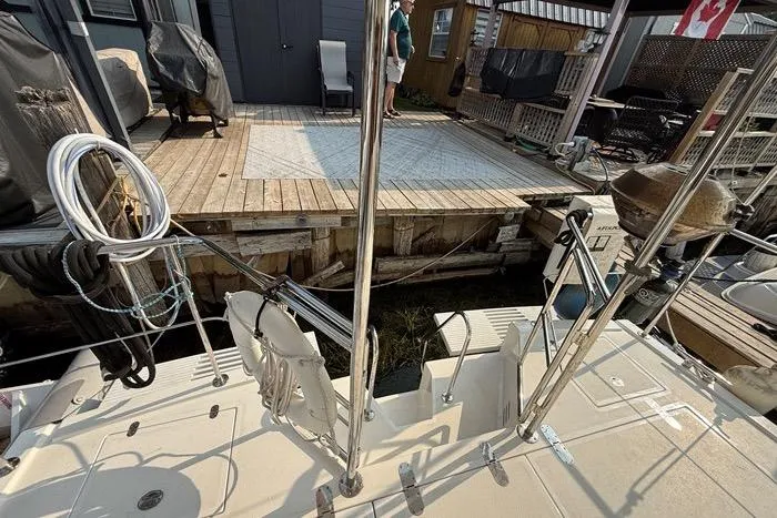  Yacht Photos Pics 2007 Island Pilot 395 yacht docked at a wooden pier with outdoor seating.