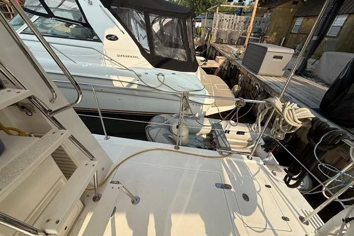  Yacht Photos Pics 2007 Island Pilot 395 yacht docked, featuring deck details and adjacent boat.