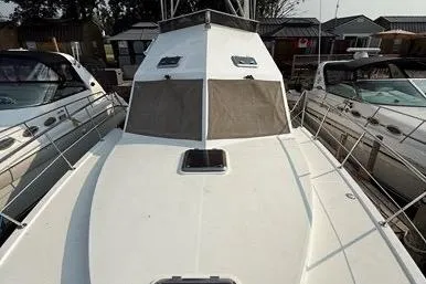  Yacht Photos Pics 2007 Island Pilot 395 boat deck with railing, docked between other vessels.