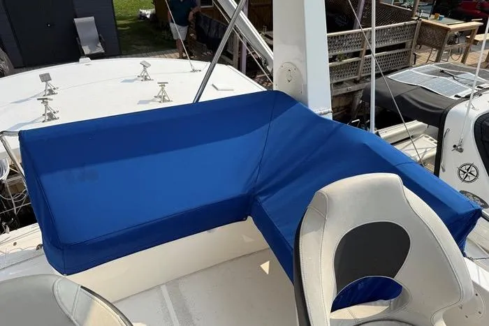  Yacht Photos Pics 2007 Island Pilot 395 boat with blue seating and white helm chair on deck.