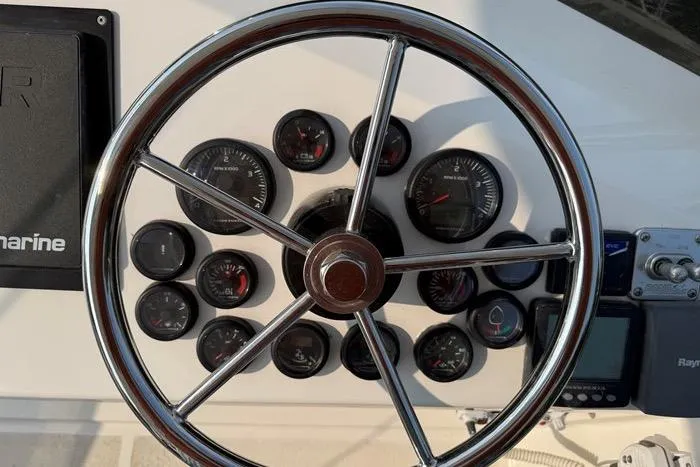  Yacht Photos Pics Steering wheel and gauges of 2007 Island Pilot 395 boat cockpit.