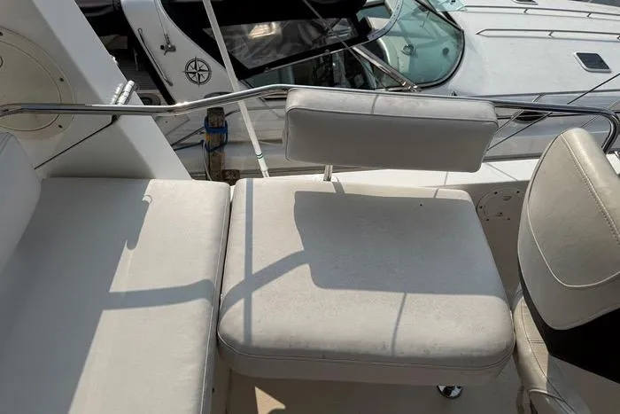  Yacht Photos Pics 2007 Island Pilot 395 boat seating area with white cushions and metal railing.
