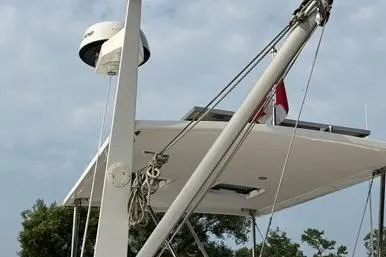  Yacht Photos Pics 2007 Island Pilot 395 yacht with radar and mast against a cloudy sky.