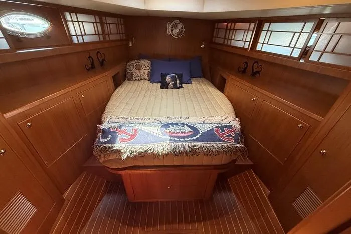 Yacht Photos Pics Luxurious 2007 Island Pilot 395 cabin interior with cozy bed and elegant wood finish.
