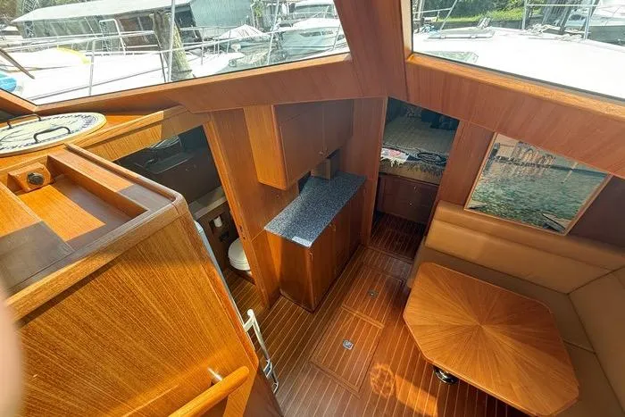  Yacht Photos Pics Interior of 2007 Island Pilot 395 yacht with wood finish and seating area.
