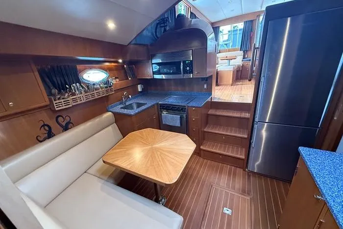  Yacht Photos Pics Luxurious 2007 Island Pilot 395 yacht interior with kitchen, dining area, and modern appliances.