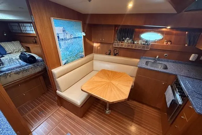  Yacht Photos Pics 2007 Island Pilot 395 interior with dining area, kitchenette, and cozy sleeping quarters.