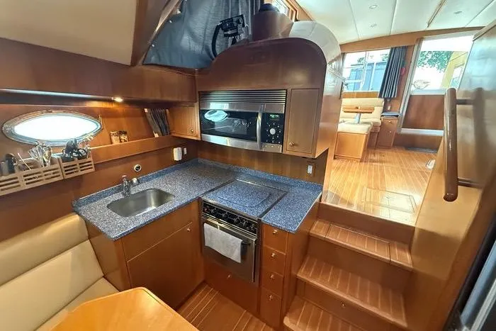  Yacht Photos Pics Luxurious 2007 Island Pilot 395 yacht interior with modern kitchen and wooden flooring.
