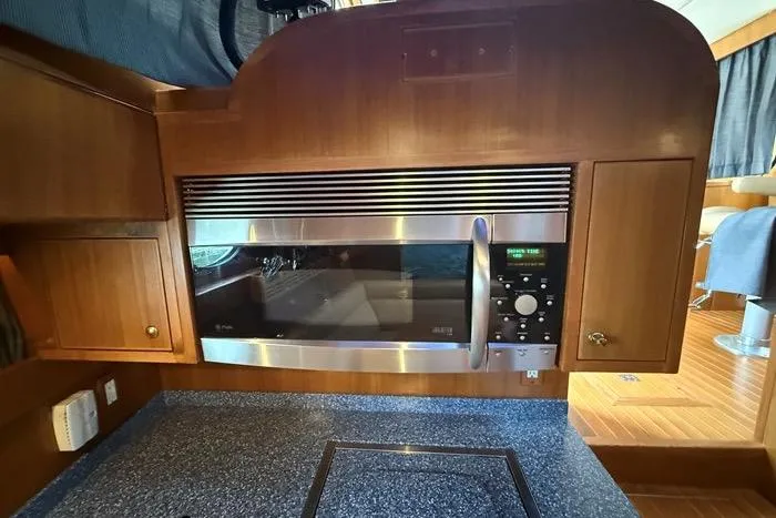  Yacht Photos Pics 2007 Island Pilot 395 yacht kitchen with built-in microwave and wooden cabinetry.