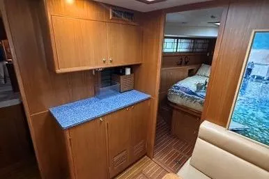 Yacht Photos Pics 2007 Island Pilot 395 interior with wood cabinetry, blue countertop, and cozy bedroom.