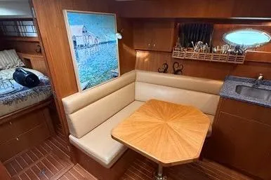  Yacht Photos Pics 2007 Island Pilot 395 interior with dining area, wooden table, and cozy seating.