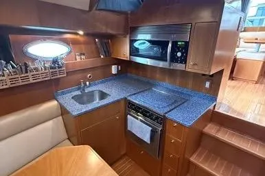  Yacht Photos Pics 2007 Island Pilot 395 yacht kitchen with modern appliances and blue countertops.