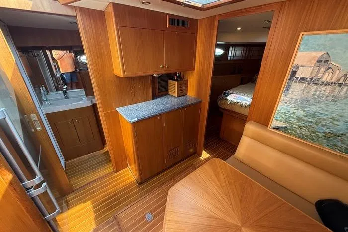  Yacht Photos Pics 2007 Island Pilot 395 interior with wood cabinetry, seating, and artwork.