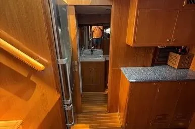  Yacht Photos Pics Interior of 2007 Island Pilot 395 yacht with wooden cabinetry and compact kitchen area.