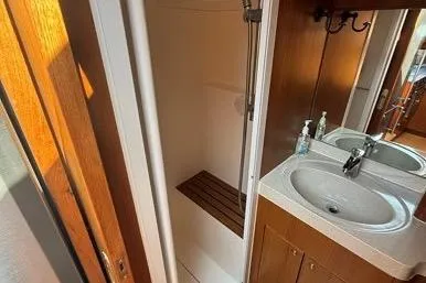  Yacht Photos Pics 2007 Island Pilot 395 yacht bathroom with shower, sink, and wooden accents.