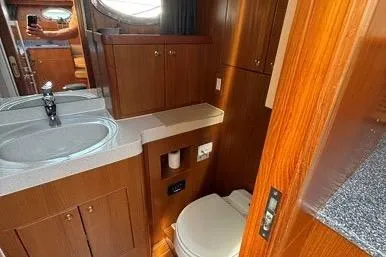  Yacht Photos Pics 2007 Island Pilot 395 yacht bathroom with wood cabinetry and modern fixtures.