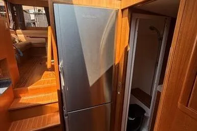  Yacht Photos Pics 2007 Island Pilot 395 interior with stainless steel fridge and wooden finishes.