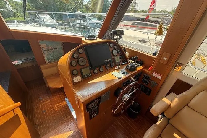  Yacht Photos Pics 2007 Island Pilot 395 helm with navigation instruments and leather seating.
