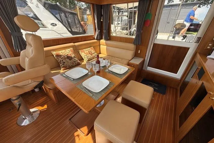  Yacht Photos Pics Luxurious 2007 Island Pilot 395 yacht interior with elegant dining setup and plush seating.