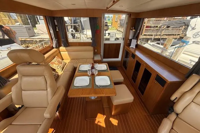  Yacht Photos Pics Luxurious interior of 2007 Island Pilot 395 yacht with elegant seating and dining area.