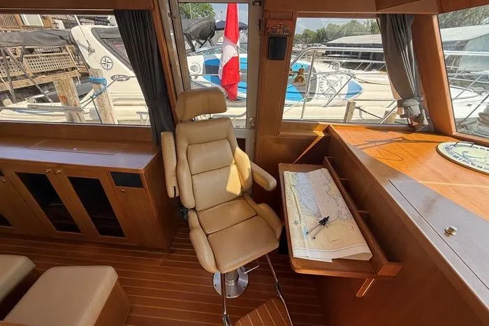  Yacht Photos Pics Pilot house interior of 2007 Island Pilot 395 with navigation chart and chair.