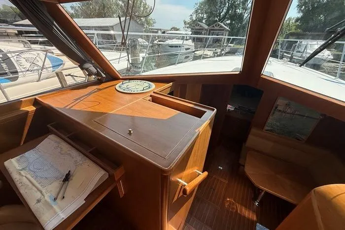  Yacht Photos Pics 2007 Island Pilot 395 yacht interior with navigation station and marina view.