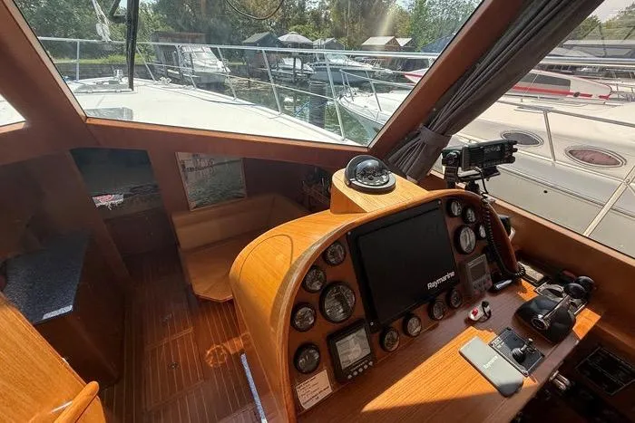  Yacht Photos Pics 2007 Island Pilot 395 helm with navigation instruments and wooden interior, docked at marina.