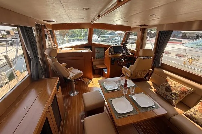  Yacht Photos Pics Luxurious 2007 Island Pilot 395 yacht interior with dining area and helm station.