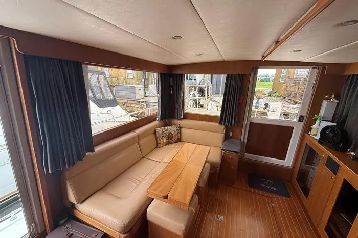  Yacht Photos Pics Luxurious interior of 2007 Island Pilot 395 yacht with cozy seating and wooden accents.