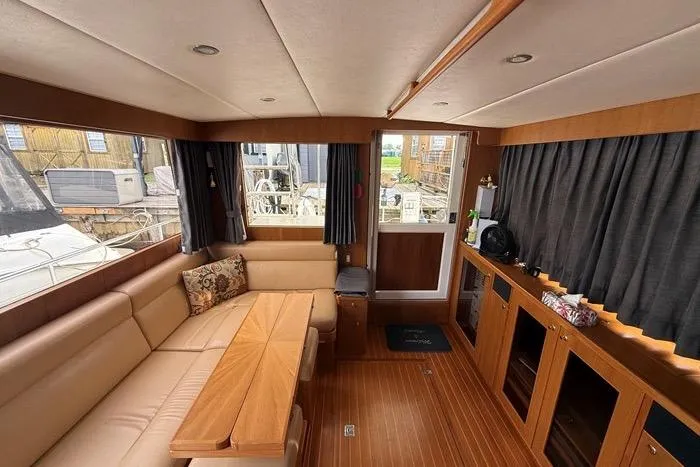  Yacht Photos Pics Interior of 2007 Island Pilot 395 yacht with wood accents and comfortable seating.