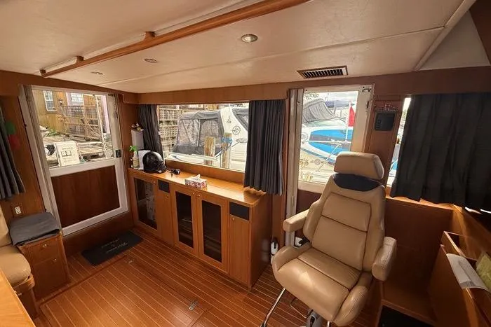  Yacht Photos Pics Luxurious interior of 2007 Island Pilot 395 yacht with leather seating and wood finishes.