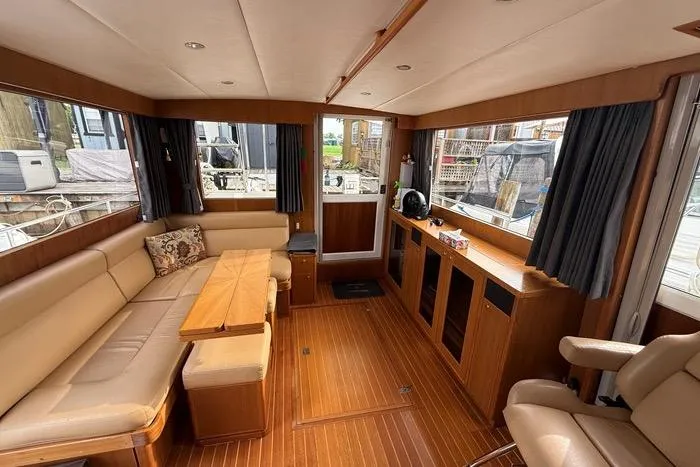  Yacht Photos Pics Luxurious interior of 2007 Island Pilot 395 yacht with wood finishes and comfortable seating.