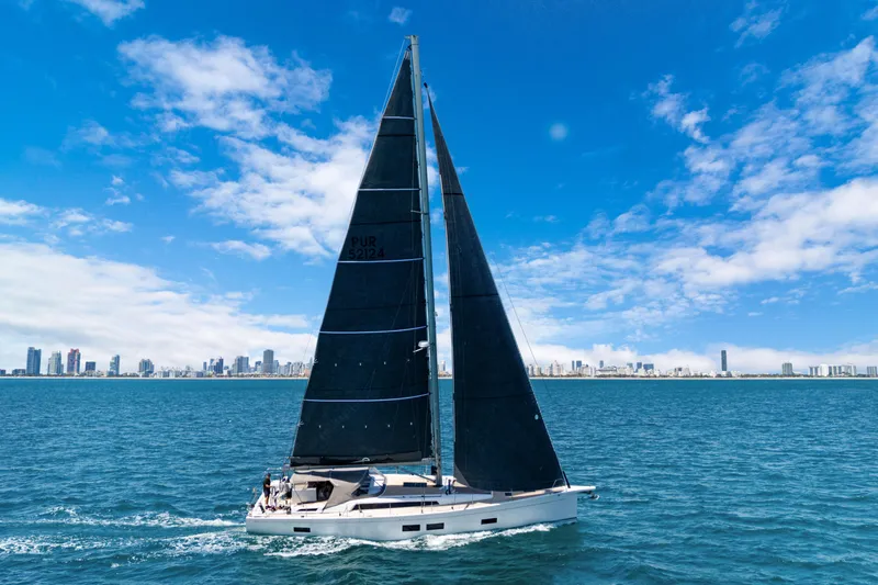 Estela Yacht Photos Pics Grand Soleil 52 Long Cruise 2017 sailing on open water with city skyline in background.