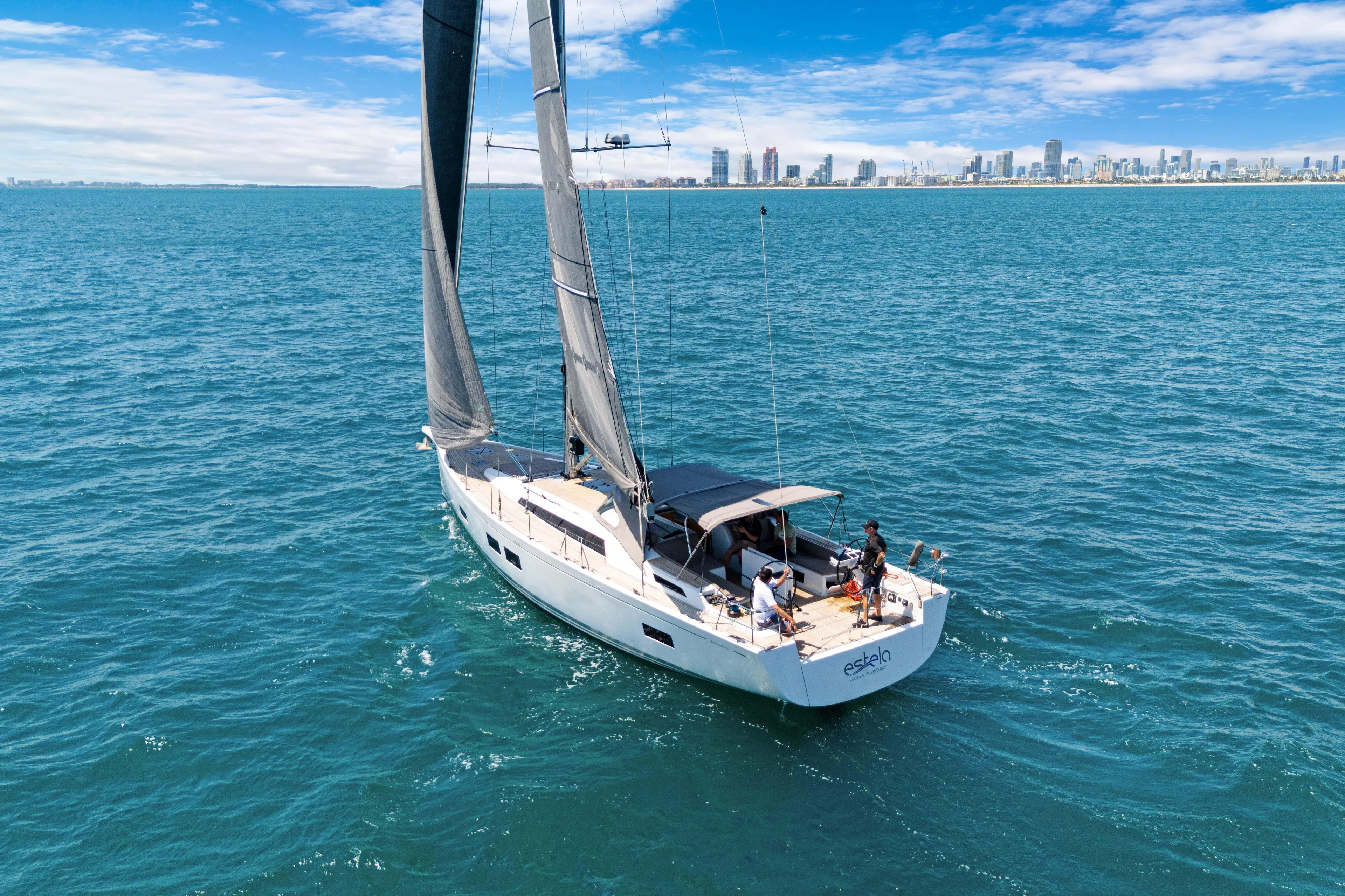 Estela Yacht Photos Pics Grand Soleil 52 Long Cruise 2017 sailing near city skyline on a sunny day.