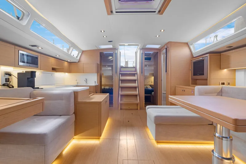 Estela Yacht Photos Pics Luxurious interior of 2017 Grand Soleil 52 Long Cruise yacht with modern furnishings and ambient lighting.