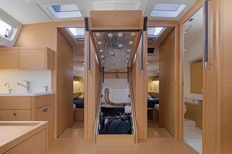 Estela Yacht Photos Pics Interior of 2017 Grand Soleil 52 Long Cruise yacht, featuring modern wood finish and engine access.