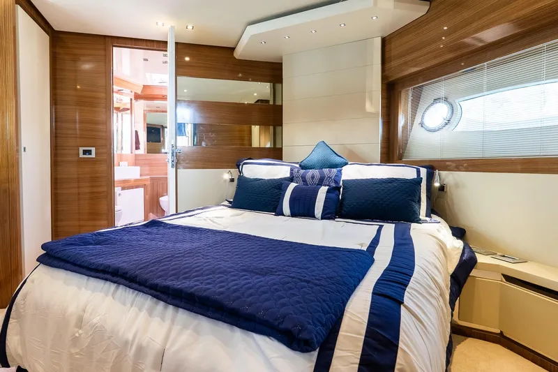 Balliamo Yacht Photos Pics Luxurious bedroom interior of 2011 Uniesse 55S yacht with elegant blue and white bedding.